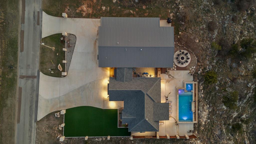 5013 Hells Gate Loop Strawn, TX 76475 - Photo 3 of 33 an aerial view of houses with yard