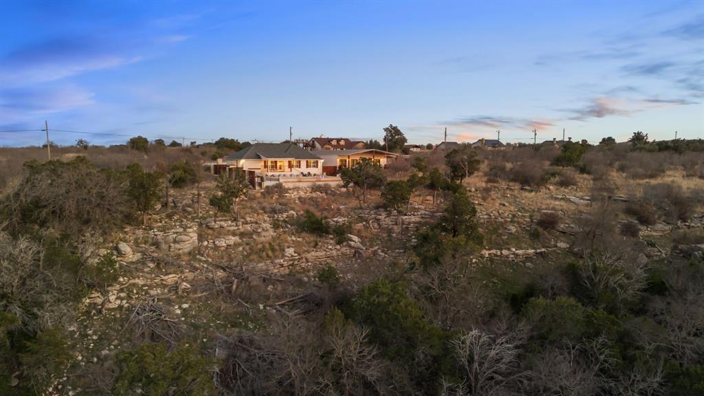 5013 Hells Gate Loop Strawn, TX 76475 - Photo 5 of 33 a view of a large building with a mountain in the background