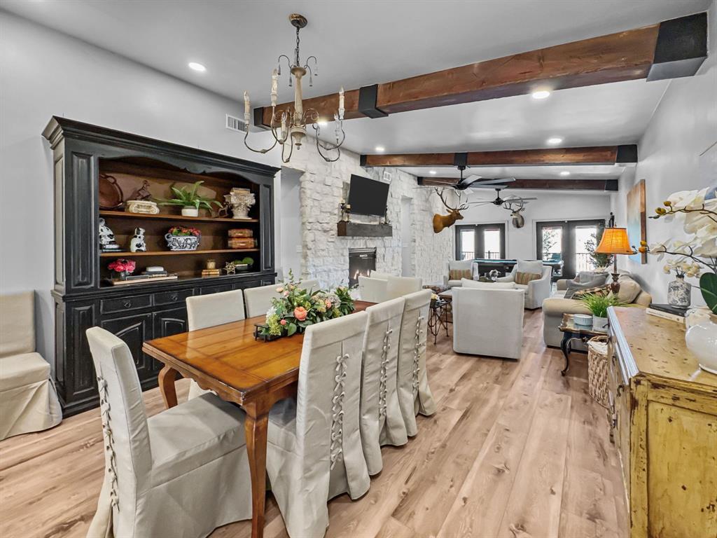 5013 Hells Gate Loop Strawn, TX 76475 - Photo 9 of 33 a living room with furniture a flat screen tv and a fireplace