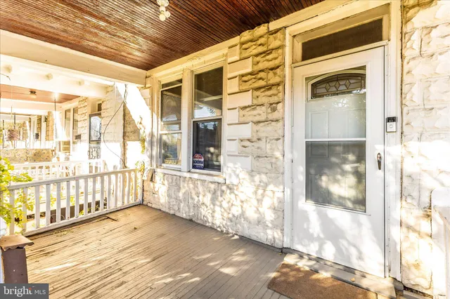 a view of a balcony with wooden floor and fence