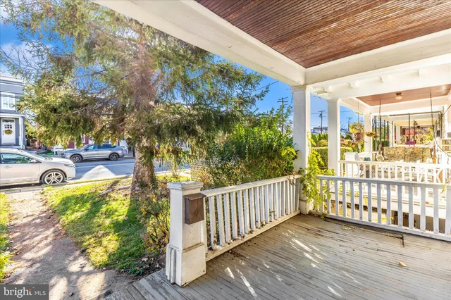 a view of a porch with a table and chairs