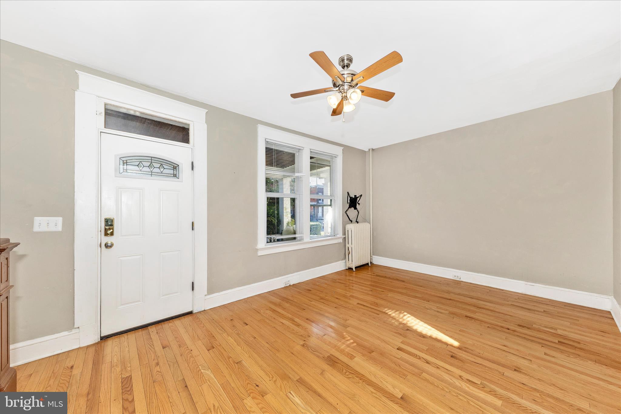 29 East 7th Street Frederick, MD 21701 - Photo 5 of 53 a view of an empty room and window with wooden floor