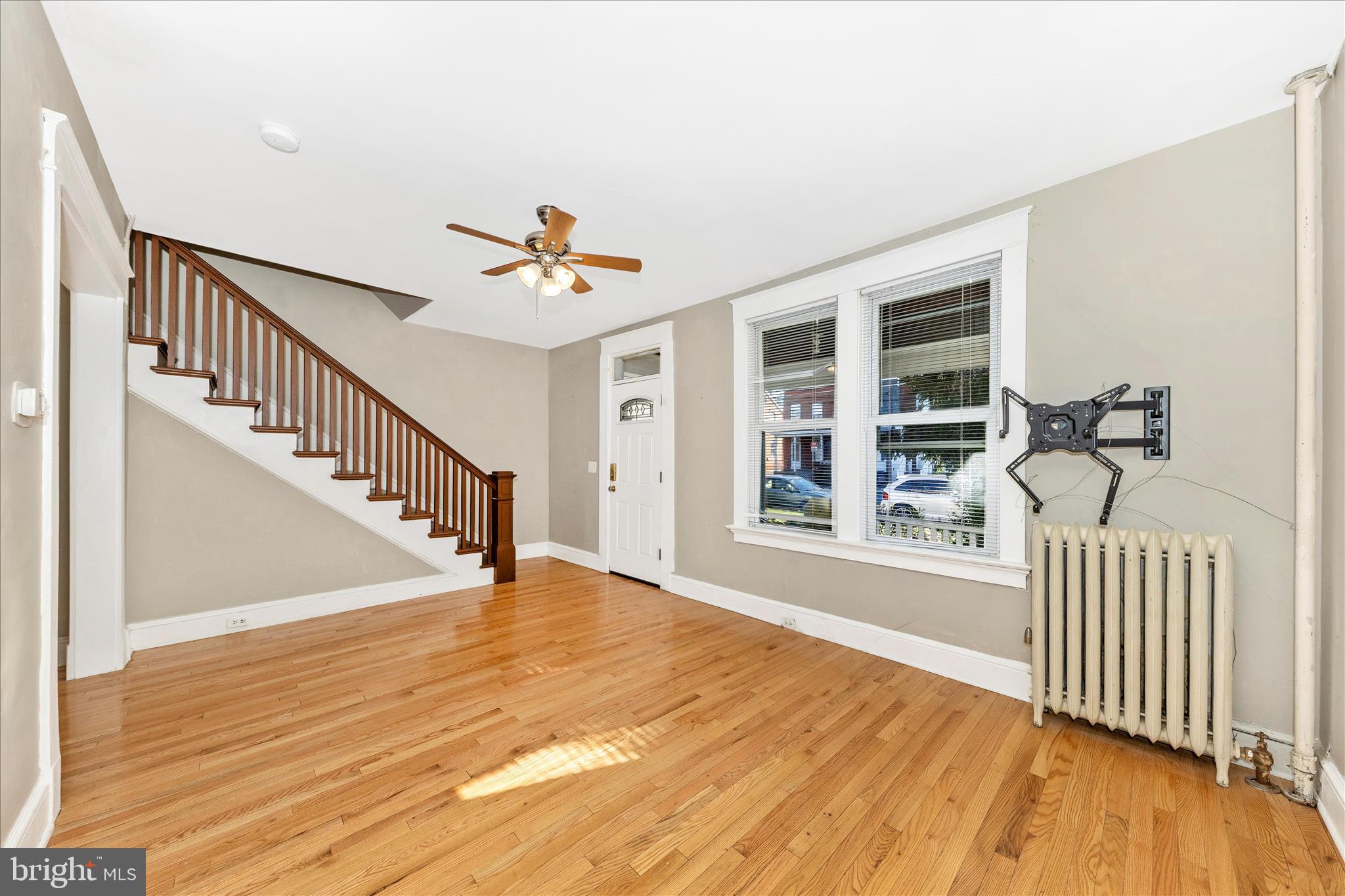 29 East 7th Street Frederick, MD 21701 - Photo 6 of 53 a view of a livingroom with wooden floor and a ceiling fan