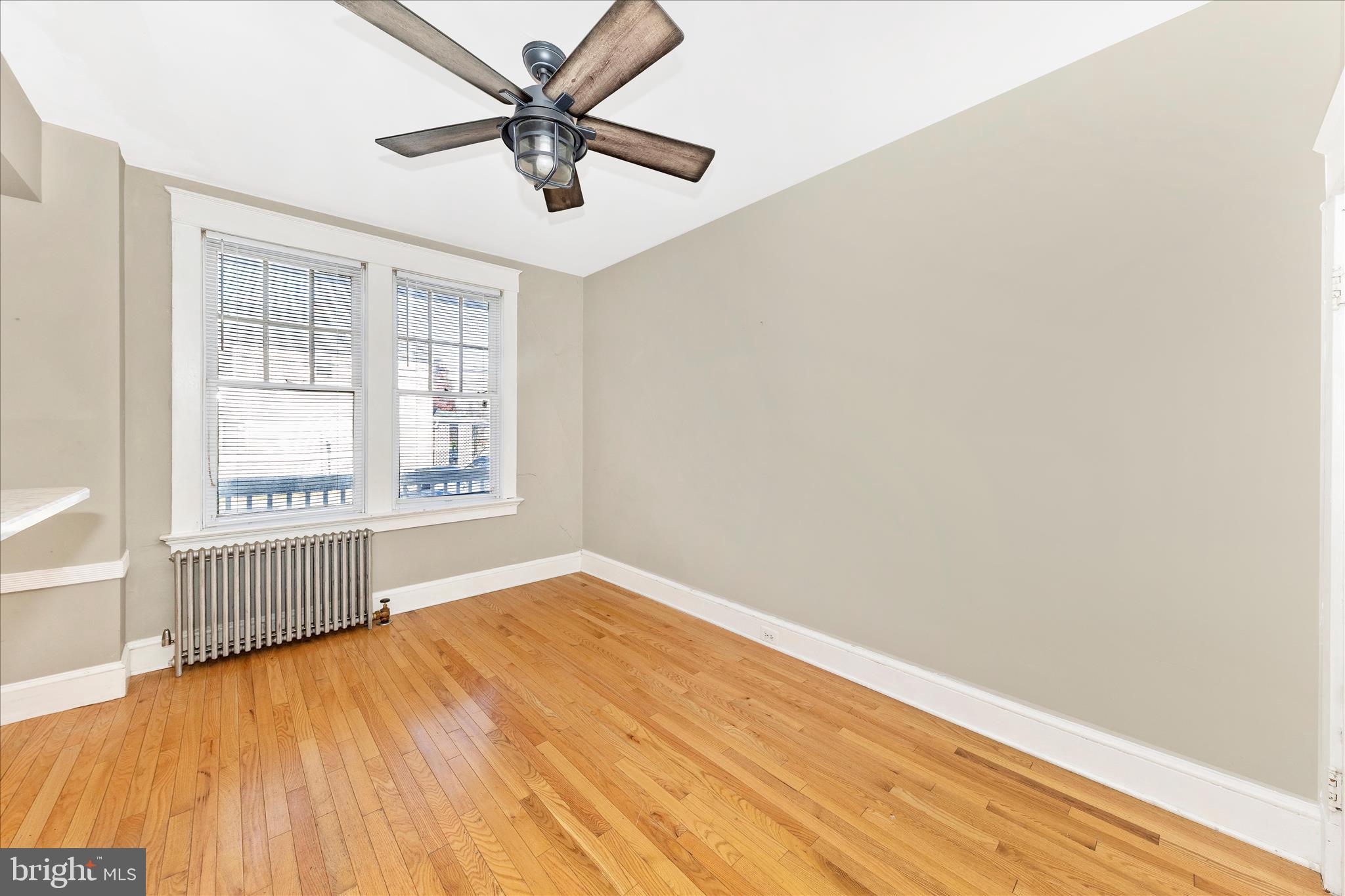 29 East 7th Street Frederick, MD 21701 - Photo 8 of 53 an empty room with wooden floor fan and windows