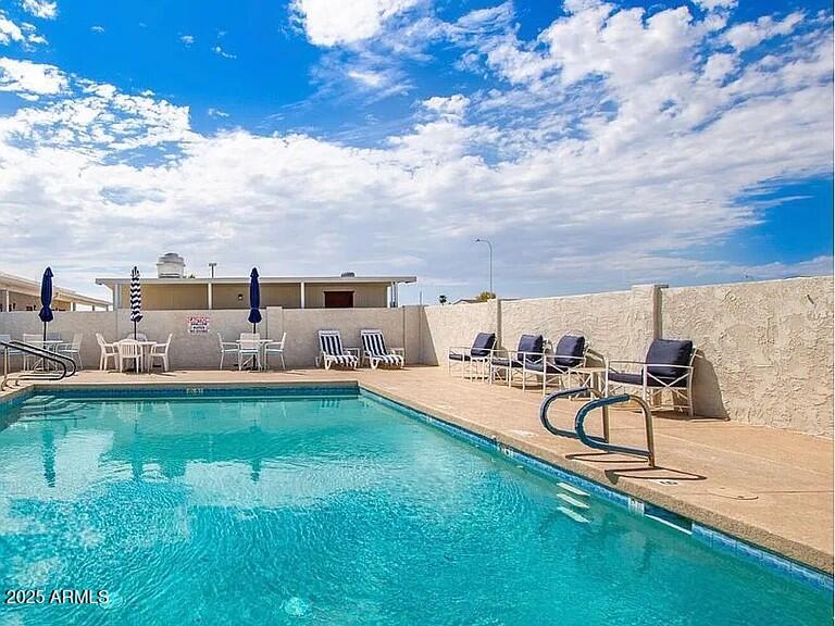 3330 East Main Street, Unit 323 Mesa, AZ 85213 - Photo 17 of 20 a view of a swimming pool from a lounge chair