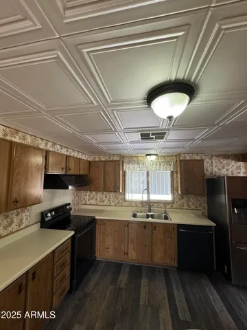 a kitchen with stainless steel appliances granite countertop a sink a stove and cabinets