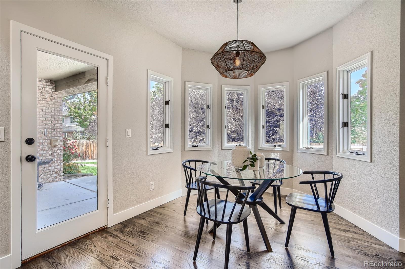 3806 Simms Court Wheat Ridge, CO 80033 - Photo 11 of 30 a view of a dining room with furniture window and wooden floor
