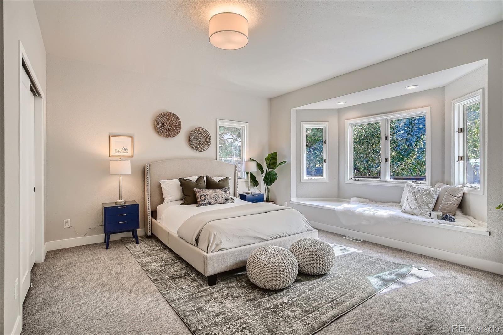 3806 Simms Court Wheat Ridge, CO 80033 - Photo 15 of 30 a bedroom with a large bed and a large window