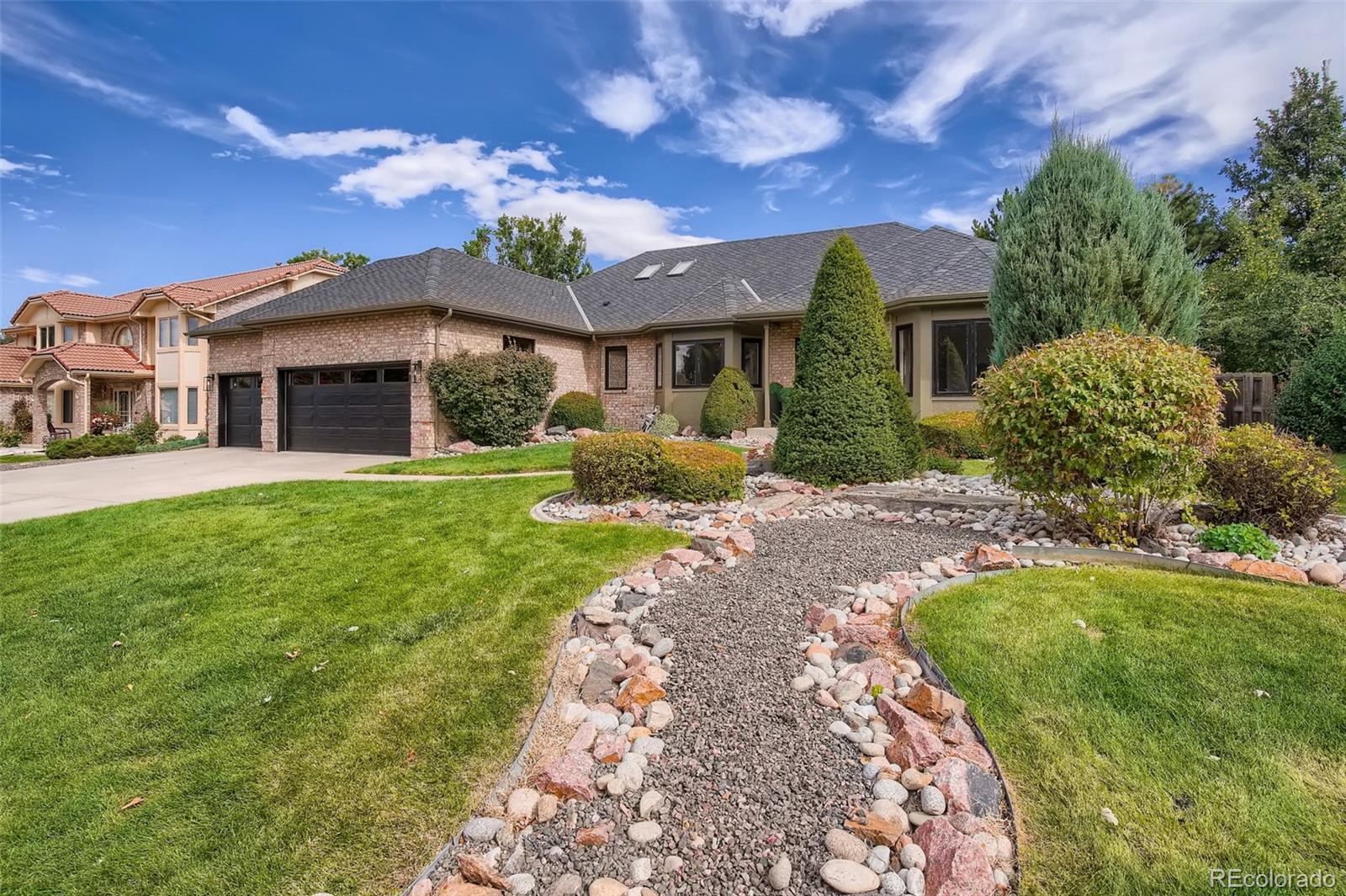 3806 Simms Court Wheat Ridge, CO 80033 - Photo 2 of 30 a front view of a house with a garden and yard