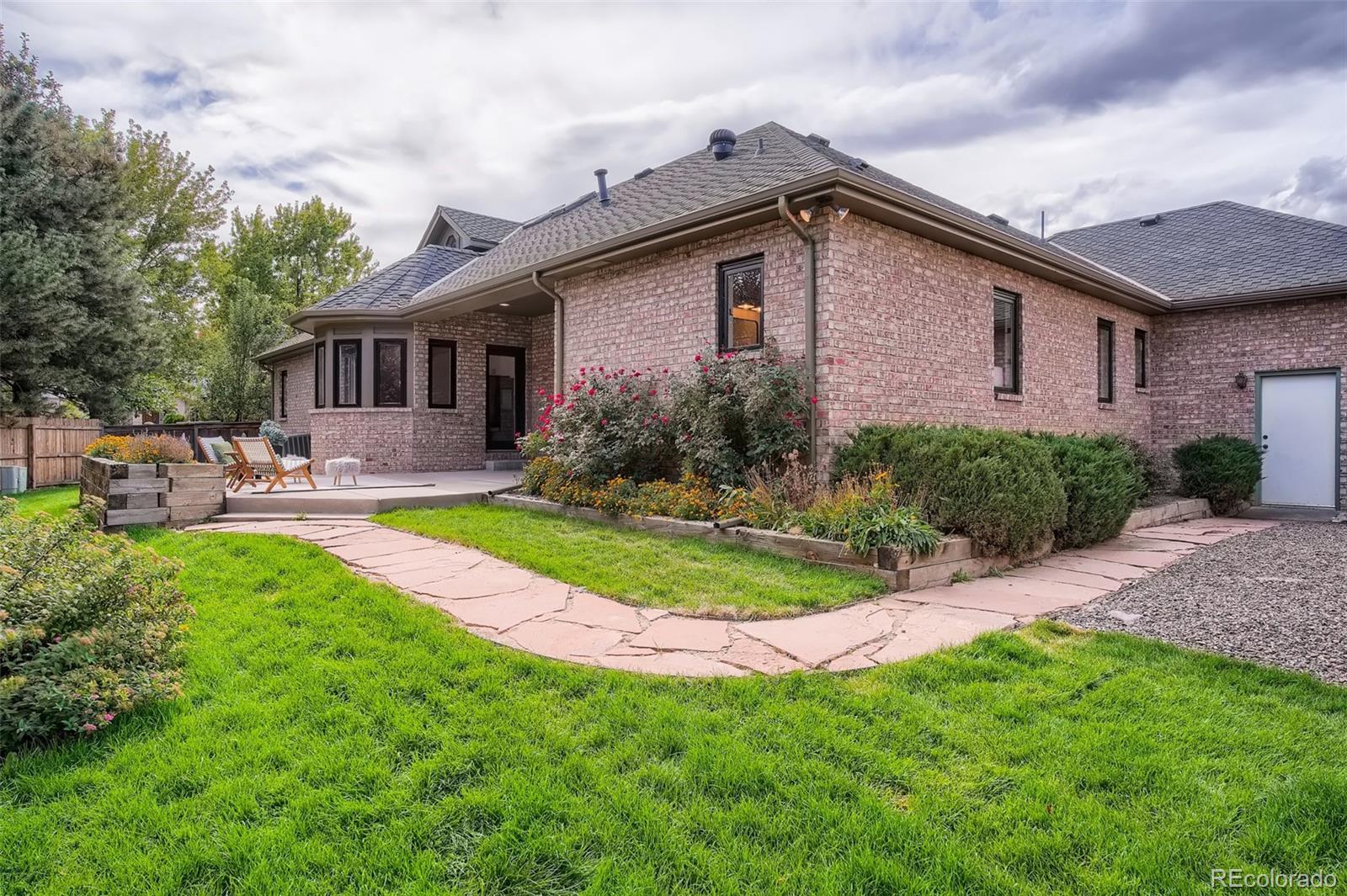 3806 Simms Court Wheat Ridge, CO 80033 - Photo 28 of 30 a front view of house with yard and outdoor seating