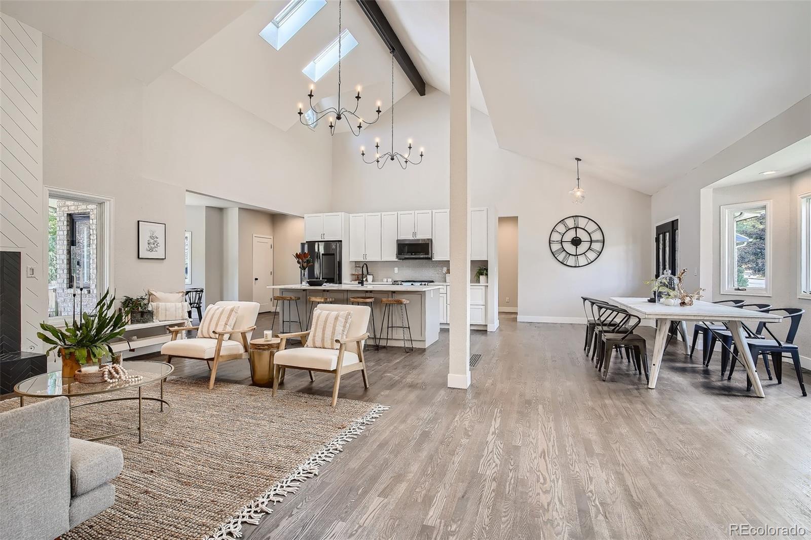 3806 Simms Court Wheat Ridge, CO 80033 - Photo 5 of 30 a living room with furniture dining table and a chandelier