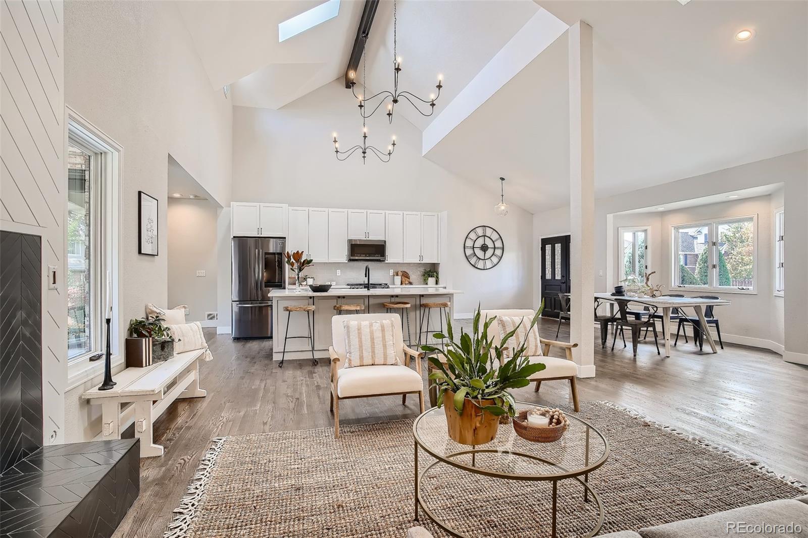 3806 Simms Court Wheat Ridge, CO 80033 - Photo 6 of 30 a living room with furniture kitchen and a chandelier