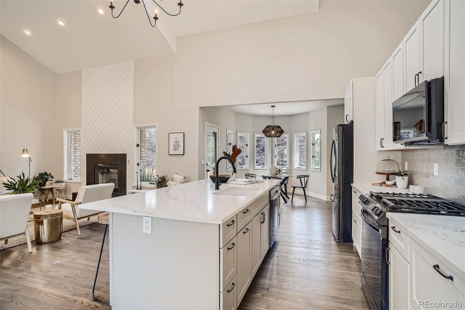 3806 Simms Court Wheat Ridge, CO 80033 - Photo 7 of 30 a large white kitchen with stainless steel appliances