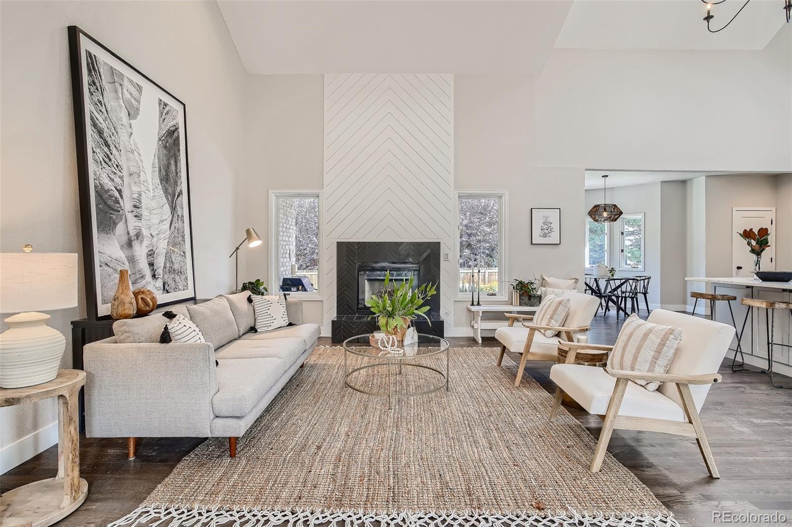 3806 Simms Court Wheat Ridge, CO 80033 - Photo 10 of 30 a living room with furniture a fireplace and a table