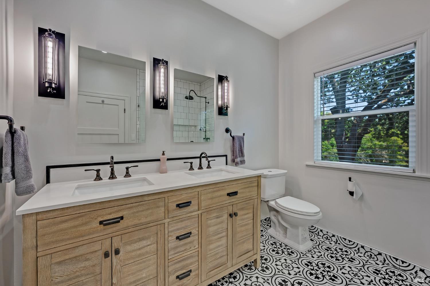 125 Cristo Lane Santa Rosa, CA 95409 - Photo 25 of 82 a bathroom with a sink a toilet a large mirror and shower