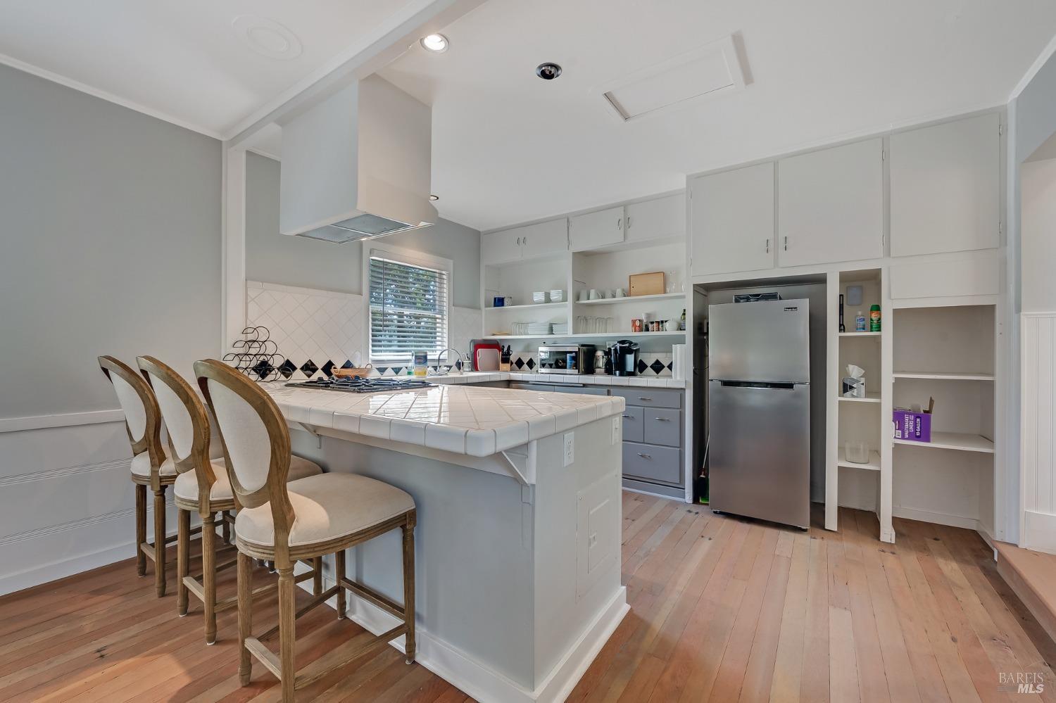 125 Cristo Lane Santa Rosa, CA 95409 - Photo 56 of 82 a kitchen with stainless steel appliances granite countertop a refrigerator a stove a sink dishwasher and a dining table with wooden floor