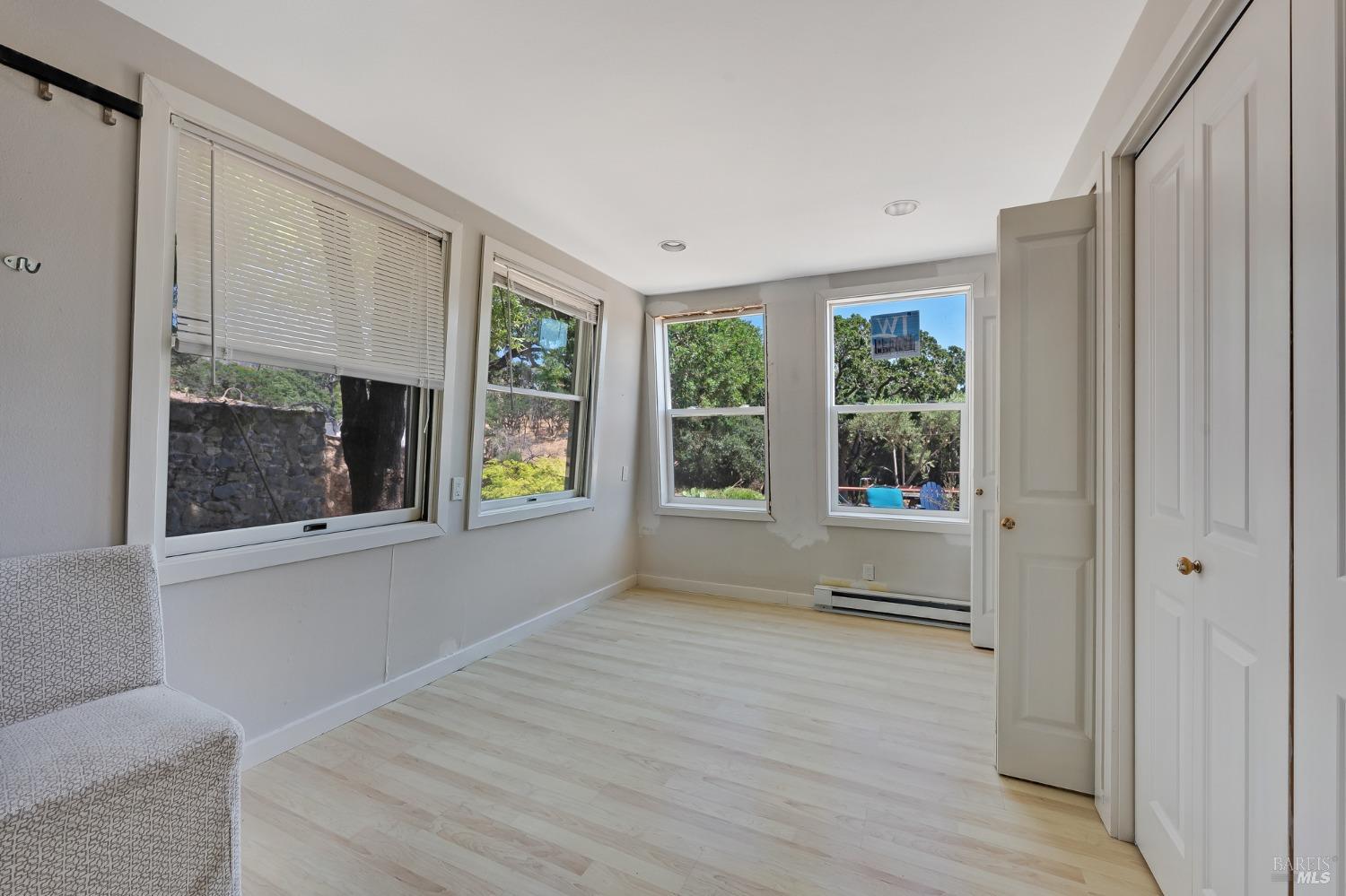 125 Cristo Lane Santa Rosa, CA 95409 - Photo 70 of 82 a view of an empty room with a window and wooden floor
