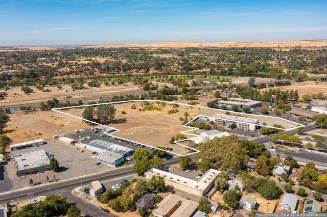 an aerial view of residential houses with city view