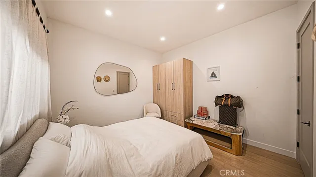 a bedroom with bed and a window