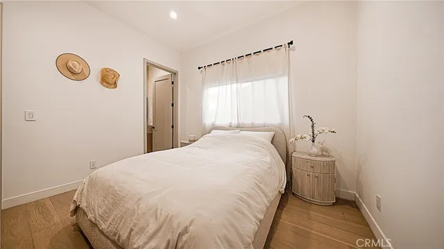 a spacious bedroom with a bed and a window