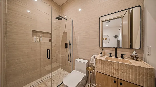 a bathroom with a toilet a sink and shower