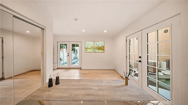 a view of a hallway with wooden floor and a living room