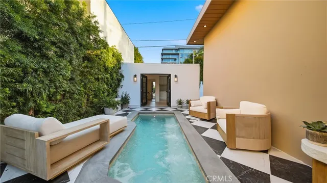 a view of a house with couches and a fire pit