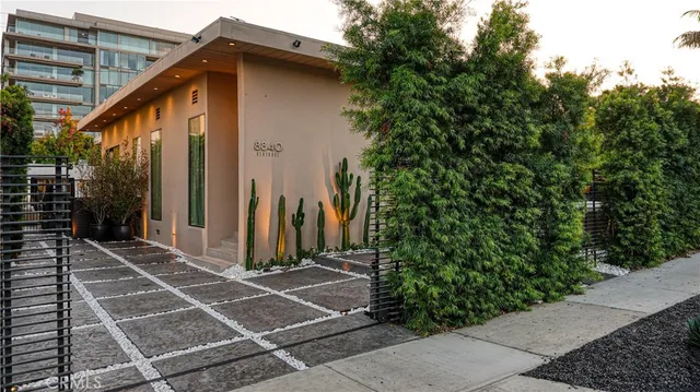 a front view of a house with a garden