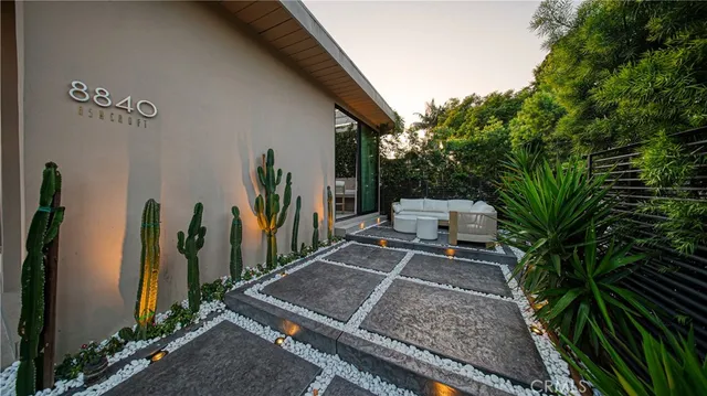a backyard of a house with table and chairs