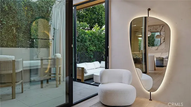 a living room with furniture and a mirror