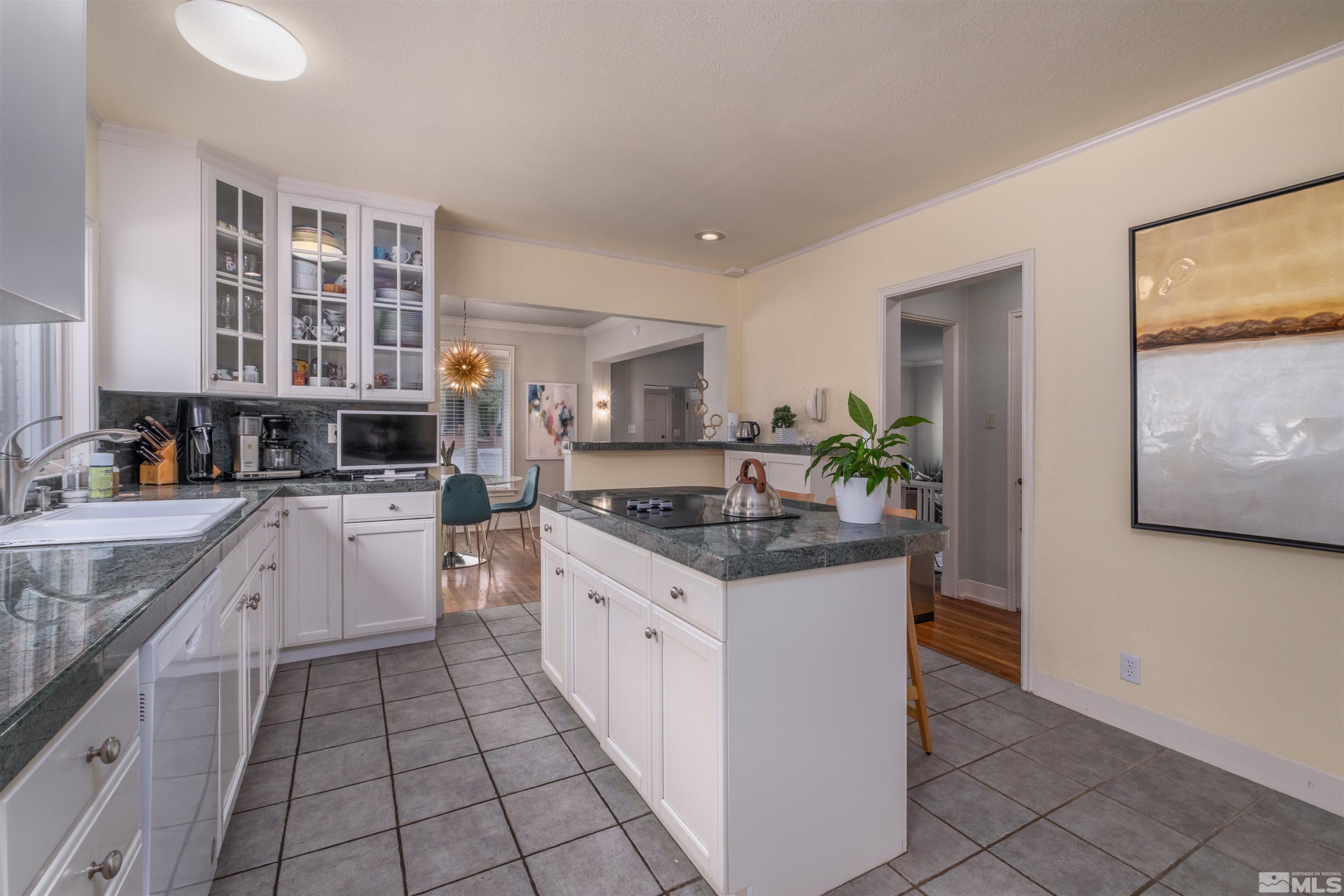 1019 La Rue Avenue Reno, NV 89509 - Photo 8 of 24 a kitchen with stainless steel appliances granite countertop a stove a sink and a microwave