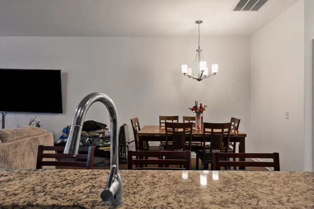 a kitchen with stainless steel appliances granite countertop a sink a stove and refrigerator