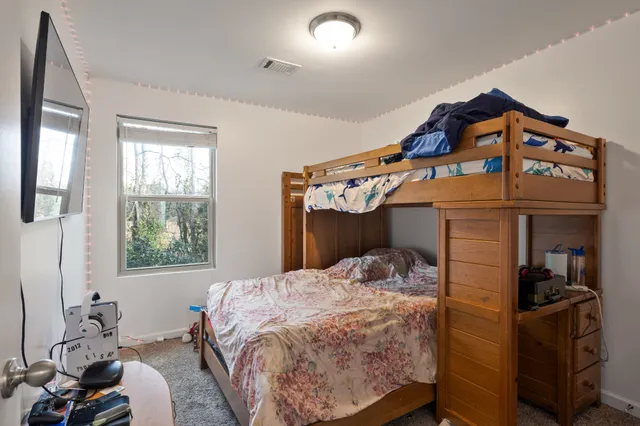 a bedroom with a bed and a tv