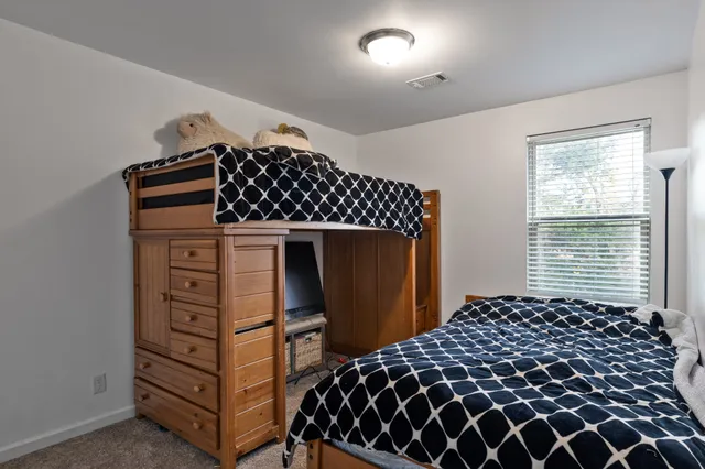 a bedroom with a bed and a dresser