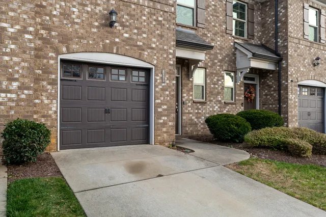 a view of a house with a small yard and plants