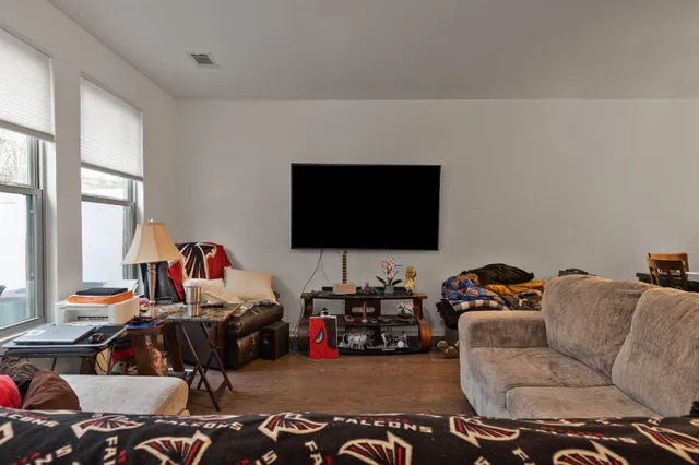 a view of a dining room with a table and chairs