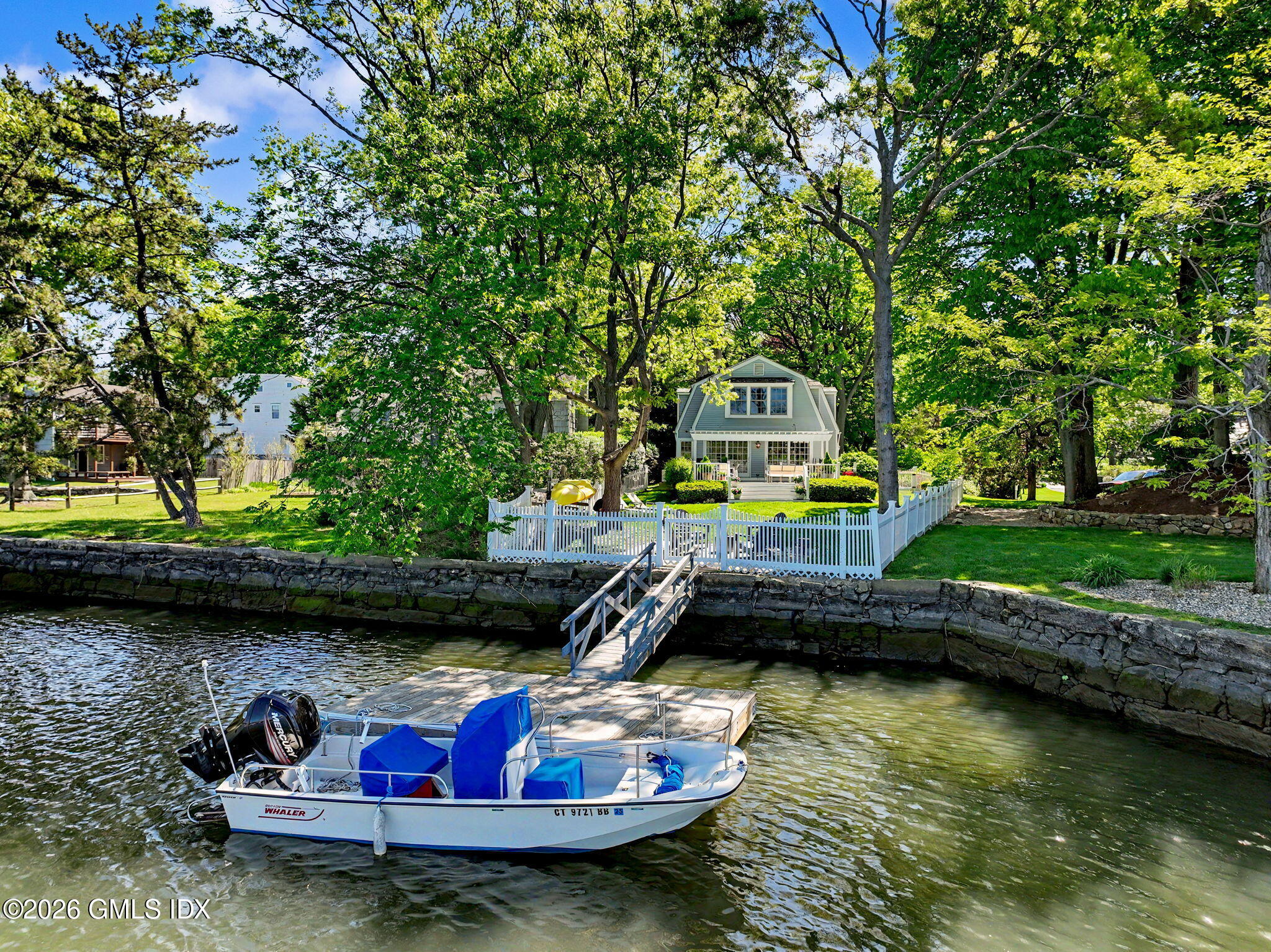 10 Newton Street Riverside, CT 06878 - Photo 3 of 28 a small pool with lawn chairs and large trees