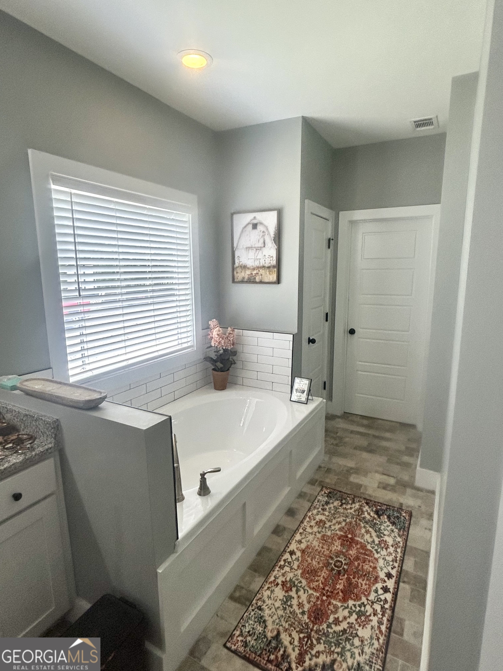 1250 Godfrey Road Madison, GA 30650 - Photo 35 of 42 a bathroom with a tub sink and a shower