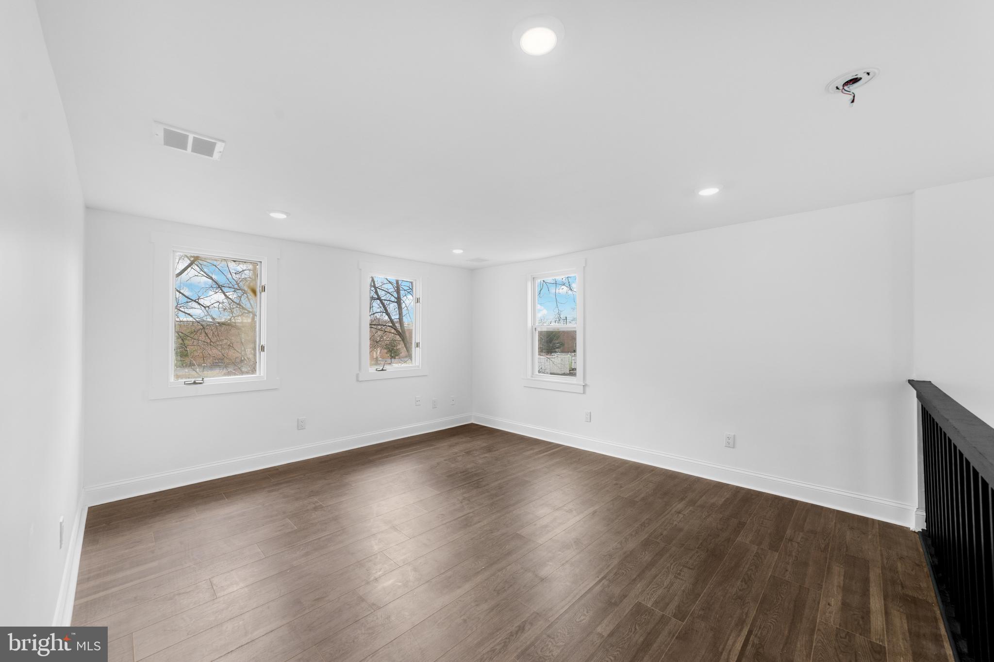 15 West Main Street Marlton, NJ 08053 - Photo 18 of 38 an empty room with wooden floor and windows