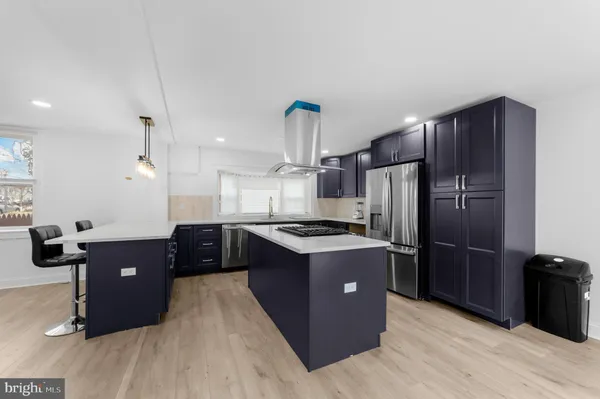 a kitchen with kitchen island wooden cabinets and stainless steel appliances