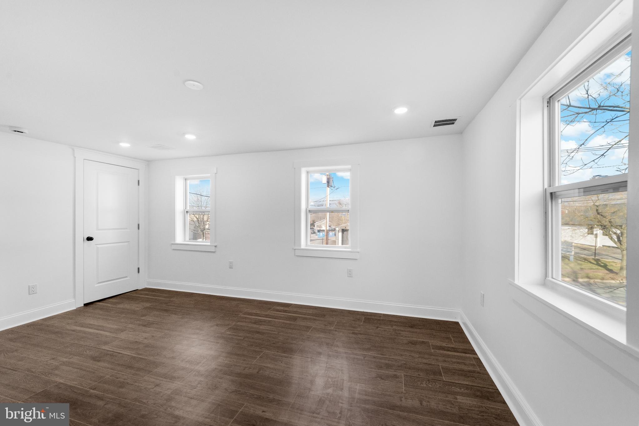 15 West Main Street Marlton, NJ 08053 - Photo 21 of 38 an empty room with wooden floor and windows