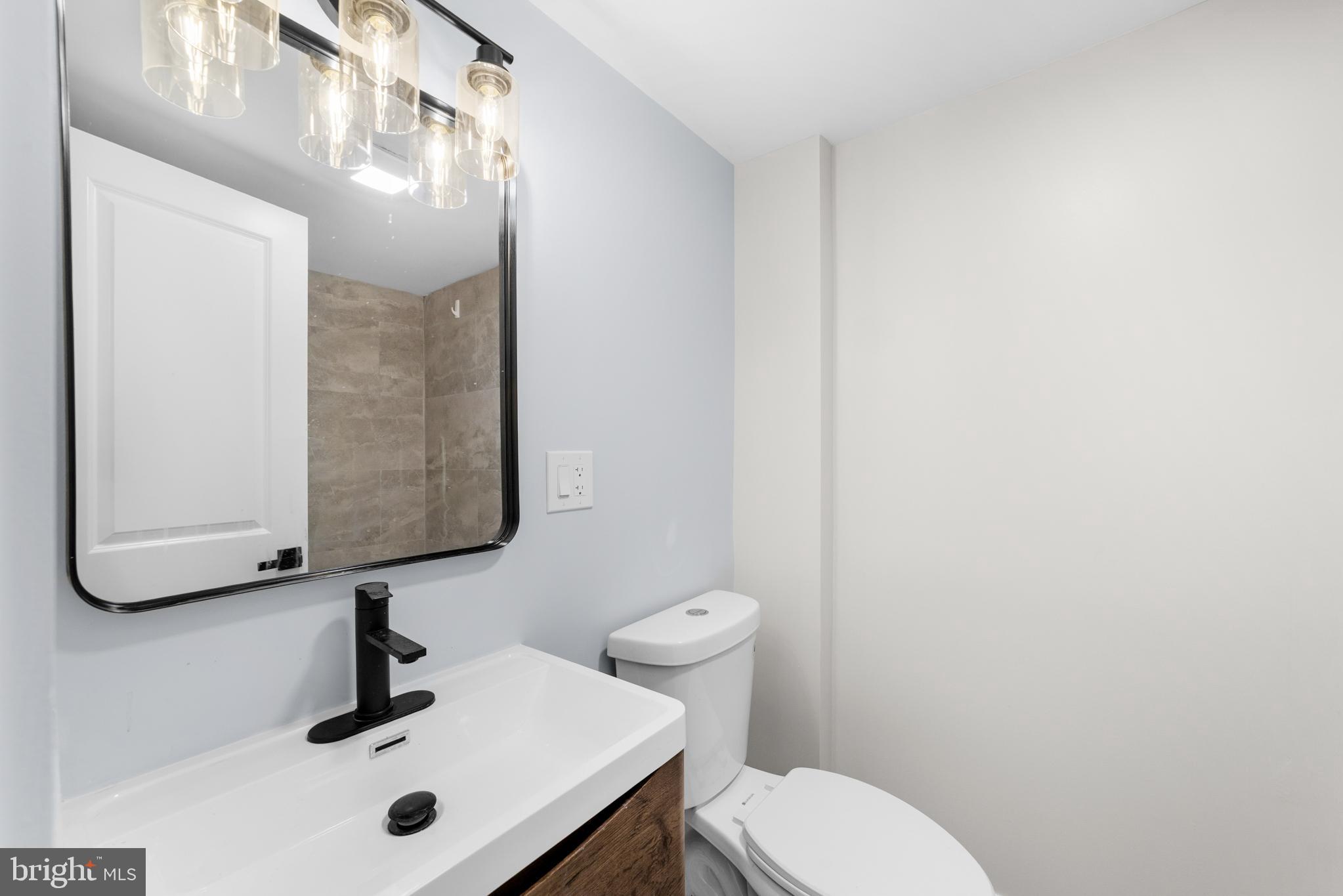 15 West Main Street Marlton, NJ 08053 - Photo 25 of 38 a bathroom with a sink a mirror and toilet
