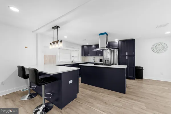 a kitchen with a sink cabinets and wooden floor