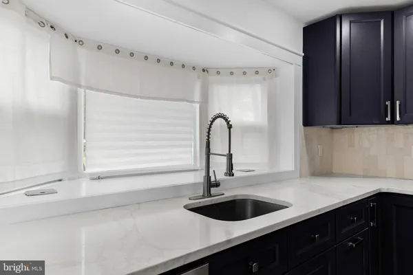 a kitchen with a sink and a refrigerator