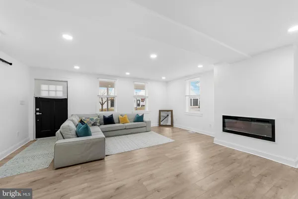 a living room with furniture wooden floor and a flat screen tv