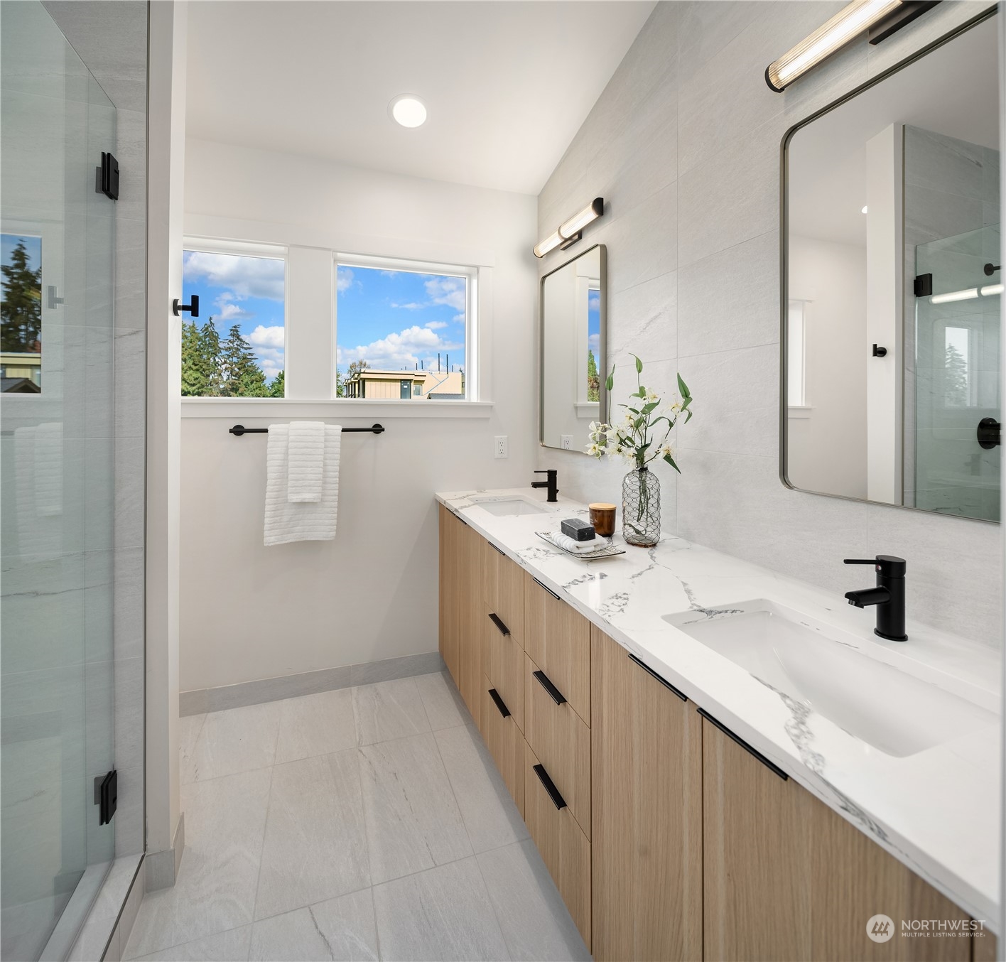 8809 B Wallingford Avenue North Seattle, WA 98103 - Photo 15 of 17 a bathroom with a double vanity sink a mirror and a shower
