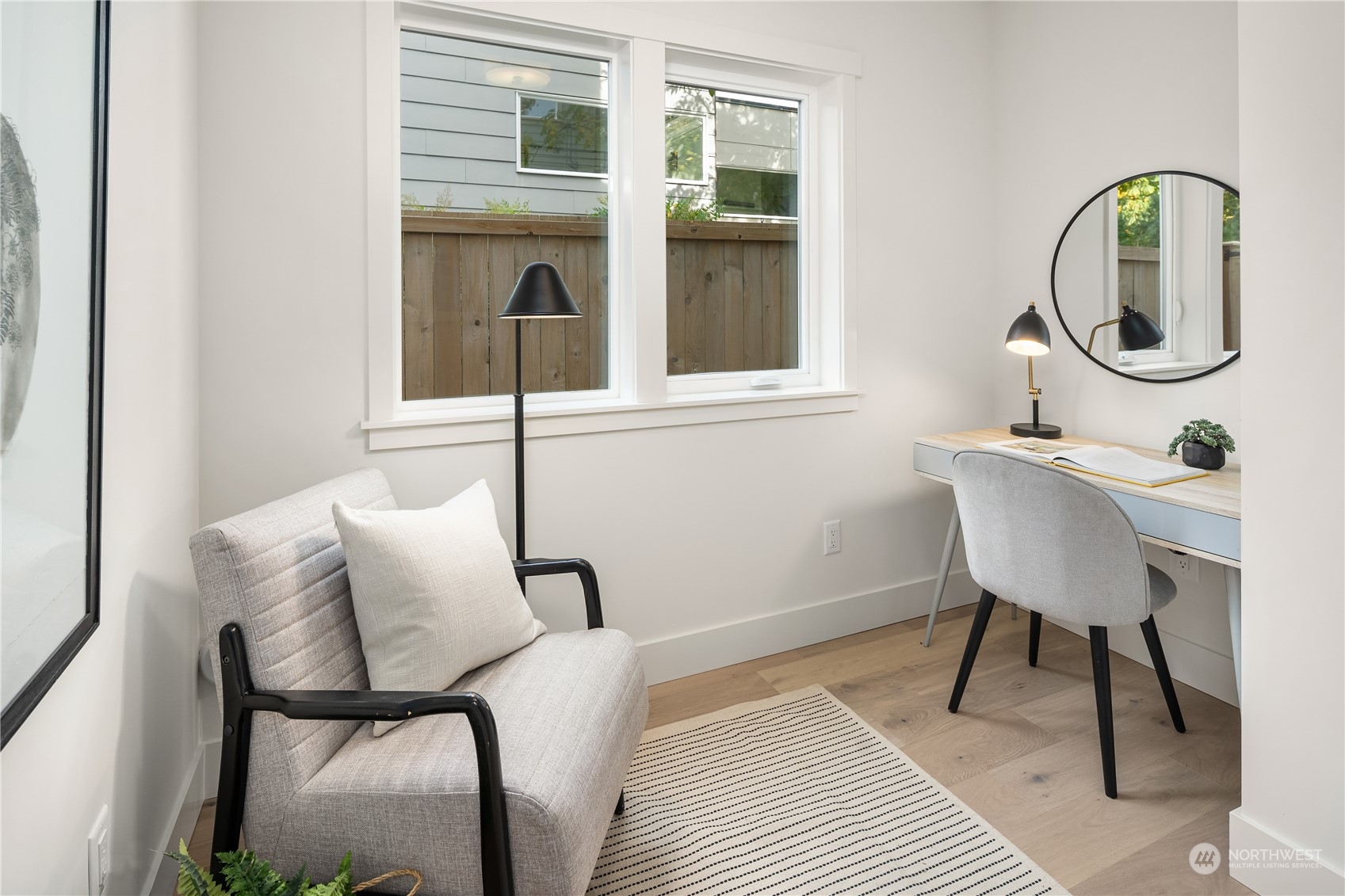 8809 B Wallingford Avenue North Seattle, WA 98103 - Photo 5 of 17 a bedroom with a bed a mirror and a window