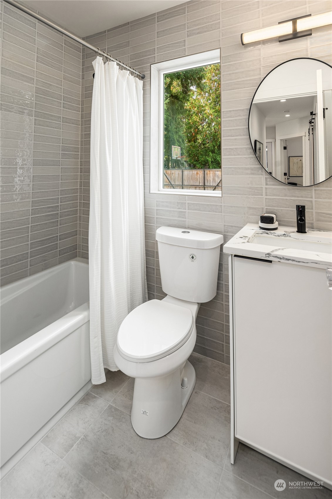 8809 B Wallingford Avenue North Seattle, WA 98103 - Photo 7 of 17 a bathroom with a toilet sink and a mirror