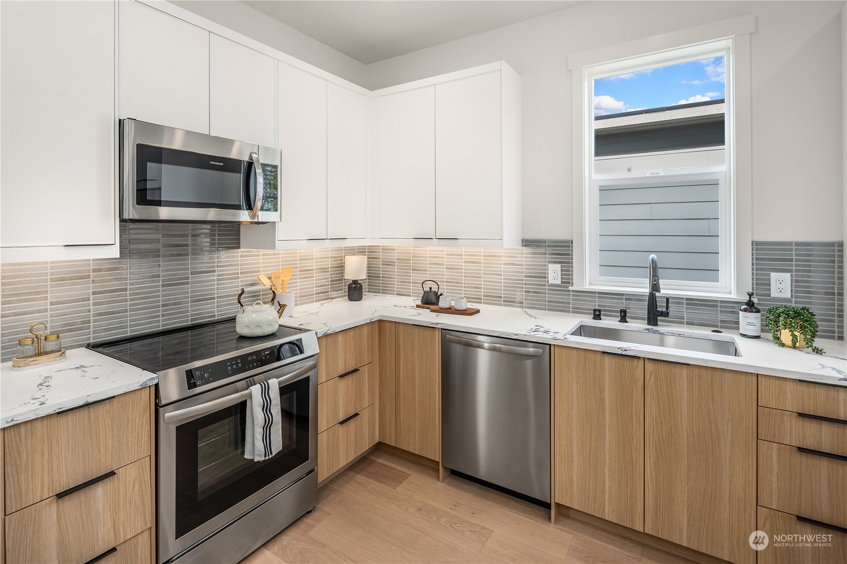 8809 B Wallingford Avenue North Seattle, WA 98103 - Photo 10 of 17 a kitchen with granite countertop a sink stainless steel appliances and cabinets
