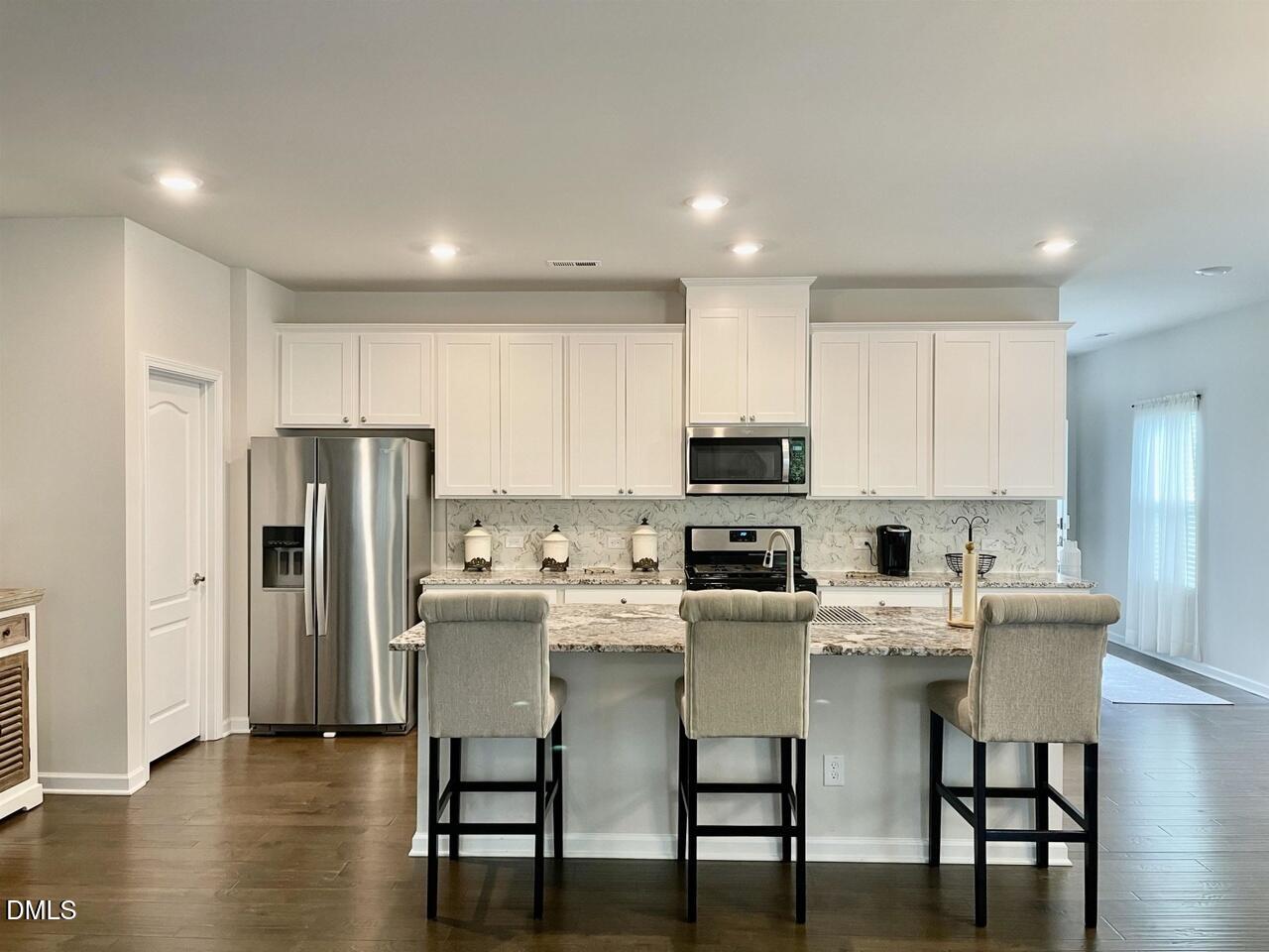 1807 Wrenn Road Durham, NC 27703 - Photo 20 of 43 a kitchen with stainless steel appliances a refrigerator stove microwave and cabinets